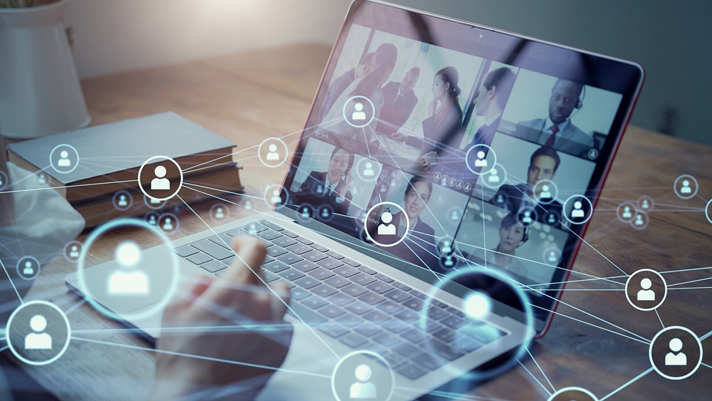 A laptop screen displaying a virtual webinar session with multiple participants, overlaid with digital icons representing network connections and user engagement. This image captures the interactive and connected nature of online webinars used for business and marketing communications.